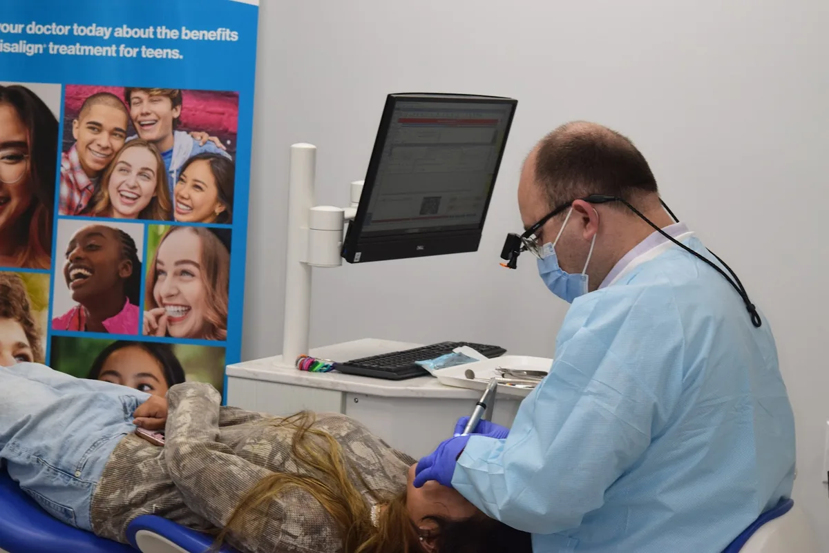 Dr. Boris Pinhasov treating a patient chairside at BP Smiles Orthodontics in Queens.
